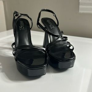 Patent leather platform heel. Never worn. New in box. Size 9.